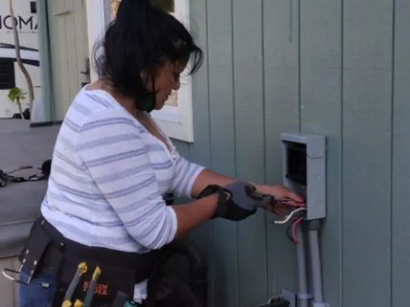Licensed electrician wiring an exterior subpanel in Lysander